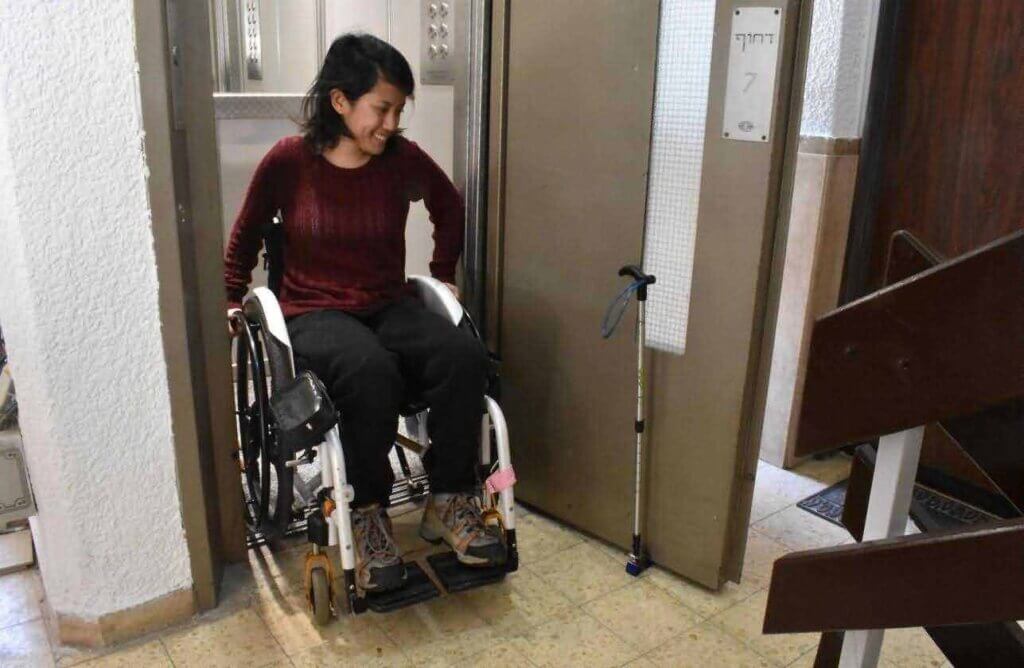 patient in wheelchairs pass through a door with an air curtain