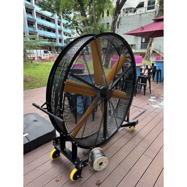 Mobile fan positioned beside outdoor restaurant seating