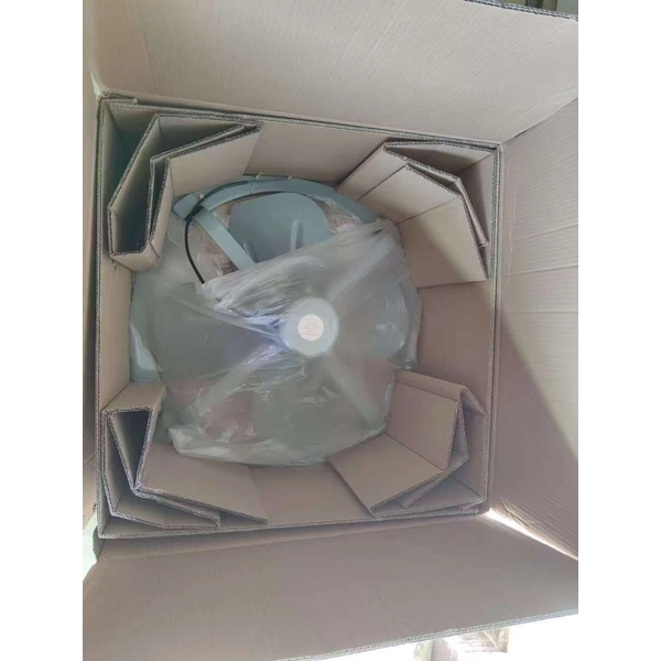 Heavy duty wall exhaust fan and protective packaging inside a cardboard carton