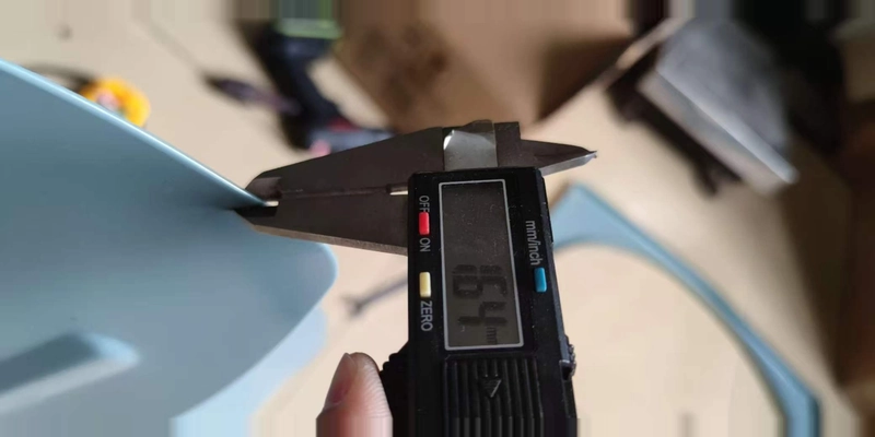 Caliper measuring the edge thickness of a GH heavy duty exhaust fan blade