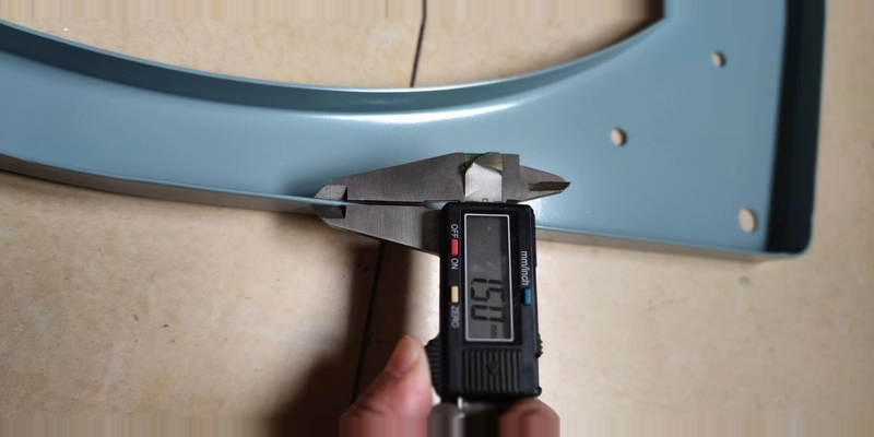 Caliper measuring the steel mounting frame of the heavy duty wall exhaust fan