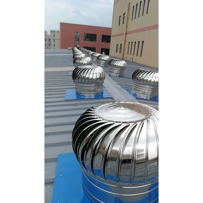 Roof turbine ventilators installed along the metal roof of a warehouse